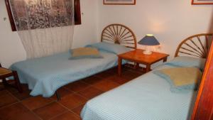 Una habitación con dos camas y una lámpara sobre una mesa. en Exclusively located Golf Villa with heated pool, en San Miguel de Abona 37 fotos más