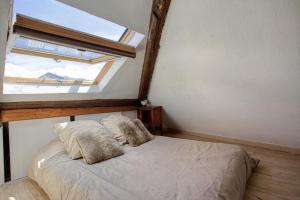 a bedroom with a bed with a large window at La Bergerie in Les Deux Alpes