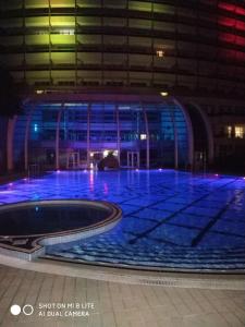 a large building with a swimming pool at night at Ялта Respect Hall in Yalta