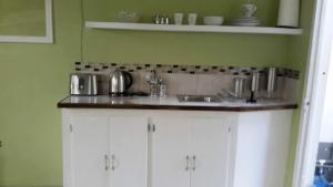a kitchen with a sink and a counter top at Lorenton Hideaway in Lucea