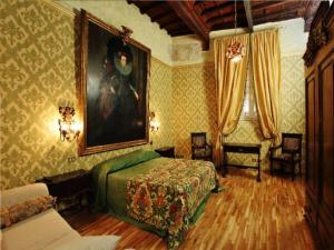 a bedroom with a bed and a painting on the wall at Antica Dimora dell'Orso in Rome