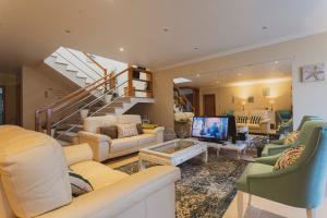 a living room filled with furniture and a staircase at Best Houses 41 - The Best Beach House in Peniche in Ferrel