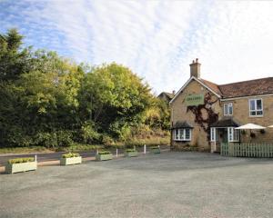 a building with a lot of plants in front of it at Parrett Hotel in South Perrott