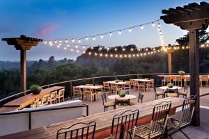 a patio with tables and chairs and lights at Chaminade Resort & Spa in Santa Cruz