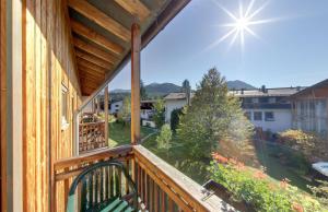 a balcony with a view of a yard at Outdoorhotel Jäger Von Fall in Lenggries