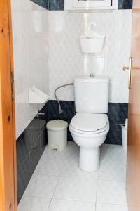 a bathroom with a white toilet and a sink at Dimitras Luxus House in Archangelos +29 photos