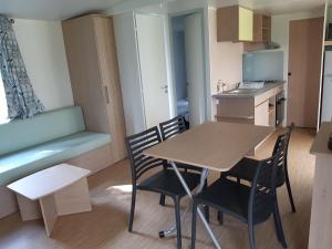 a small kitchen with a table and chairs in a room at Relais du Haget in Cravencères