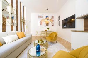 a living room with a couch and a table at Luxury home in PARIS - Musée du Louvre in Paris