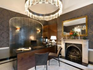 ロンドンにあるスタントン ホテル - B&Bのデスク、暖炉、シャンデリア付きのオフィス