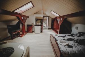 a bedroom with a bed and a table and a tv at Cherry apartmani in Gornji Milanovac