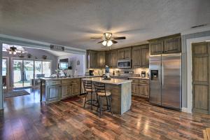 a large kitchen with wooden floors and stainless steel appliances at Riverfront Cottage Fire Pit and Kayaks in Deltaville