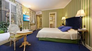 a hotel room with a bed and a table at Hôtel Beaubourg in Paris