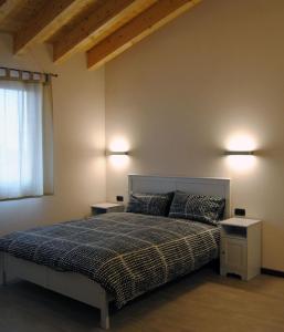 a bedroom with a bed and two night stands at Cascina Bosco Gerolo in Rivergaro