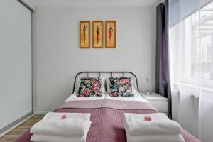 a white bedroom with a bed with two pillows at TriApart Amber Jantar III in Jantar