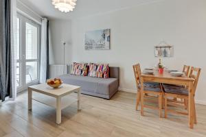 a living room with a table and a couch at TriApart Amber Jantar III in Jantar