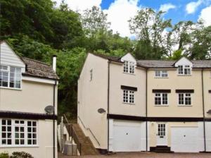 a large white house with two garage at Symonds Yat West Holiday Cottage 8 WRC with views of Yat Rock in Symonds Yat