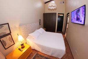 um quarto com uma cama e uma televisão na parede em Fundo San Jose Parque Ecológico & Lodge Hotel Asociado Casa Andina em La Merced