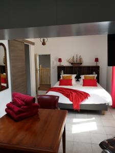 a bedroom with a large bed with red pillows at atmosphere in Poilhès
