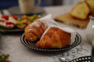 a plate with two croissants on a table at B & B Station69 in Fasano