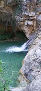 a waterfall next to a pool of water at Casa Elina I I in Lucena del Cid