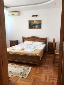 a bedroom with a bed and a picture on the wall at Casa Nursil in Eforie Nord