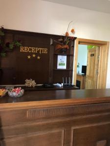 a bar in a hotel with a reception desk at Casa Nursil in Eforie Nord