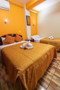 Postel nebo postele na pokoji v ubytování Hotel Suite Plaza
