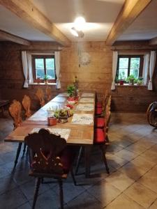 a dining room with a wooden table and chairs at Rębiszów 50 in Rebiszów