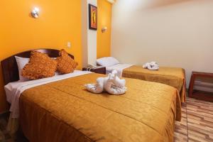 Postel nebo postele na pokoji v ubytování Hotel Suite Plaza