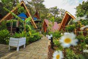 a garden with a row of houses and flowers at Likya Evleri Olympos in Olympos
