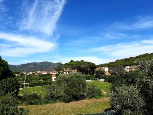 a view of a town with trees and a blue sky at Villa Very II in Marina di Campo