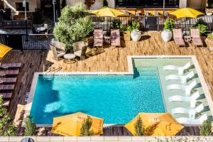 an overhead view of a swimming pool with umbrellas at Hotel ZaZa Houston Memorial City in Houston