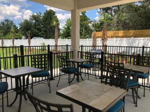 a row of tables and chairs on a patio at Candlewood Suites - Panama City Beach Pier Park, an IHG Hotel in Panama City Beach
