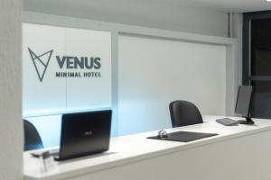 an office with a desk with a laptop and a window at Venus Minimal Hotel in Tinos