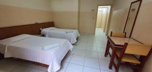 Tempat tidur dalam kamar di Hotel Plaza Olido