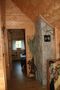 a hallway in a log cabin with a stone wall at Robakówka in Ochotnica Dolna