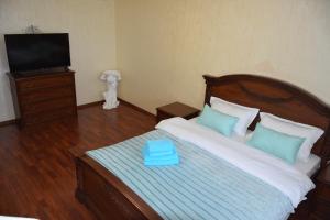 a bedroom with a bed with a blue box on it at Мода в доме 13 in Oral