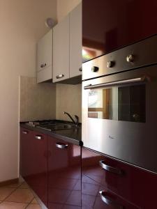 a kitchen with a sink and a stove top oven at Casa Aceri Rossi in Chiesa in Valmalenco