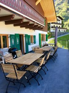 a group of tables and chairs outside of a building at Frühstückspension Sonnblick in Stuben am Arlberg