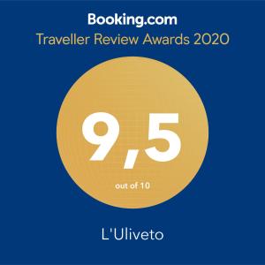 a yellow circle with the number nine and the text travelling review awards at L'Uliveto in Reitano