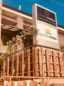 a hotel sign and a fence in front of a building at Albergo Fonda in Villarotta