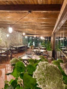 a restaurant with tables and chairs and plants at Agriturismo Sant'Alfonso in Furore