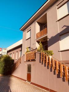 a building with wooden balconies on the side of it at Albergo Fonda in Villarotta