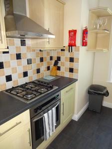 a kitchen with a stove and a counter top at Freshford House in Weymouth