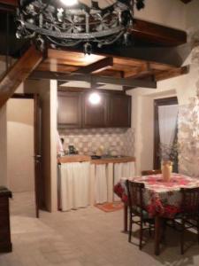 a kitchen with a table and a dining room at Apartments Parco d'Abruzzo in Bisegna