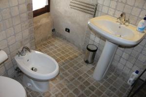 a bathroom with a toilet and a sink at Apartments Parco d'Abruzzo in Bisegna