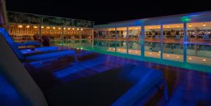 a swimming pool at night with blue lights at Hotel Pantelidis in Ptolemaida