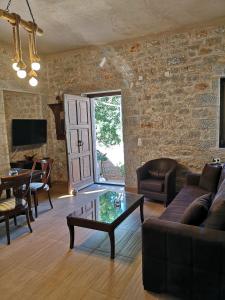 a living room with a brick wall at Παραδοσιακός πύργος in Yerolimin