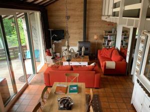 a living room with a red couch and a table at Modern Holiday Home in Stavelot with Terrace in Stavelot