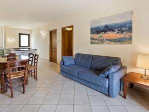 a living room with a blue couch and a table at Elegant Holiday Home in Sorano with Swimming Pool in Sorano